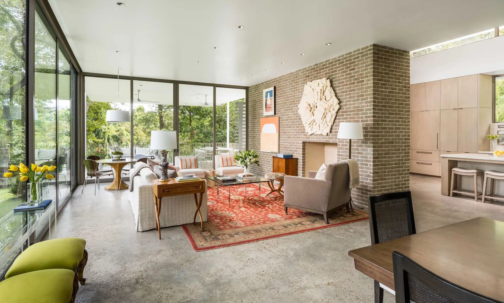 Open-concept living room with brick fireplace wall and integrated lighting in a Houston home